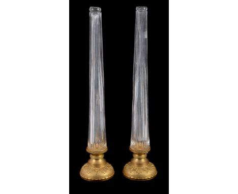  A pair of gilt metal mounted moulded glass lamp bases,   second half 20th century, the tapering stems descending to waisted 