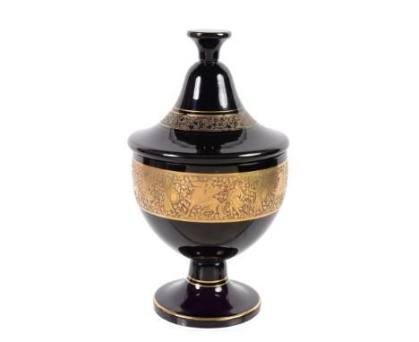  Moser, an amethyst glass goblet and cover,   1920s, with gilt oroplastic figural banding, rubbed oval mark to cover, 30cm hi