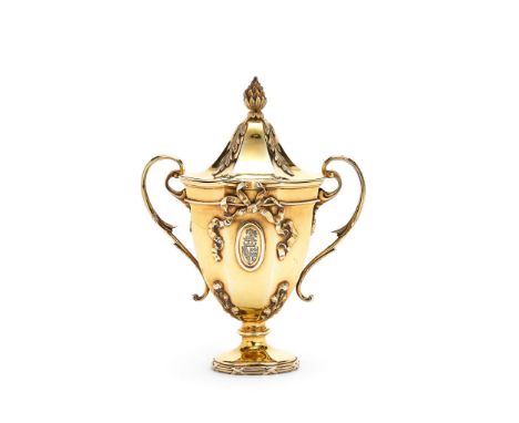  An Edwardian silver gilt cup and cover by George Fox,   London 1903, with a pine cone finial to the domed octagonal cover, t