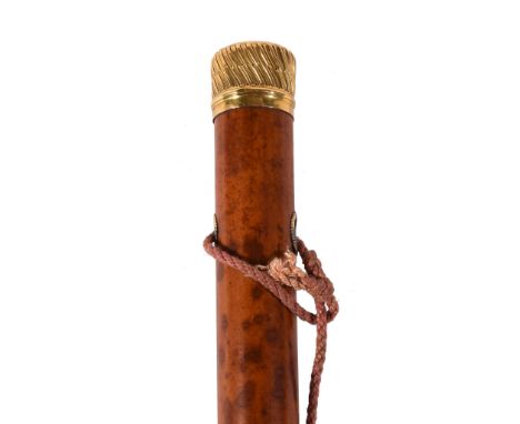  A late 18th century gold and malacca walking stick,   the grip with gadrooned decoration, the top with scrolling initials  R