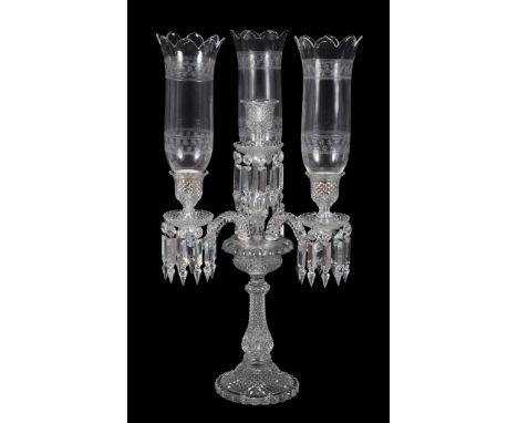  A modern Baccarat press-moulded and clear glass four-light table candelabrum,   stencil mark, with three associated storm sh