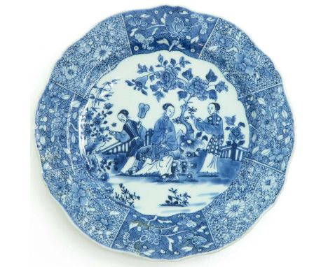 Blue / white decor in under glaze, depicting ladies playing in the garden, 26 cm. in diameter, chip.