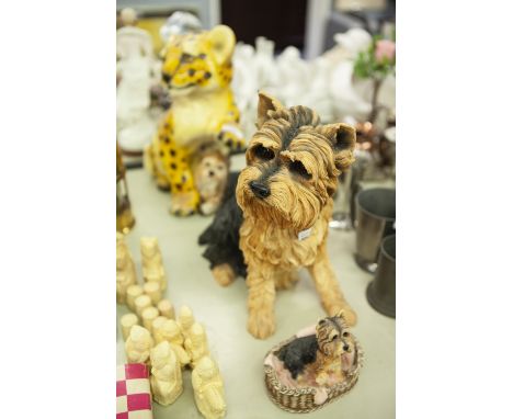 A LARGE RESIN MODEL OF A TERRIER, A LEONARDO RESIN ORNAMENT OF A TERRIER IN A BASKET AND A PLASTER MODEL OF A RECLINING TERRI