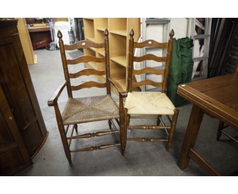 A SET OF SIX IRANIAN OAK LADDER BACK DINING CHAIRS WITH RUSH SEATS AND LOOSE SQUAB CUSHIONS, INCLUDING A PAIR OF CARVERS ARMC
