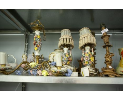 THREE GILT METAL FIGURAL CANDLESTICKS, TWO FLORAL TABLE LIGHTS, SIMILAR CEILING LIGHT  AND TWO OTHERS 