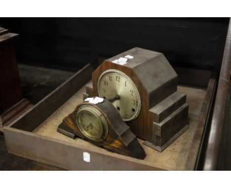 AN ART DECO OAK CASED MANTEL CLOCK, THE SHAPED ANGULAR CASE HAVING SILVERED DIAL AND BLACK NUMERALS AND A SMALLER EXAMPLE (2)