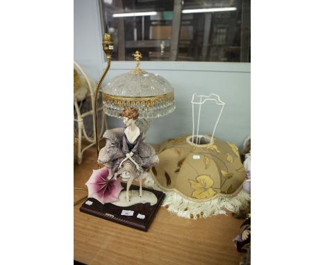 'FLORENCE' PORCELAIN FEMALE FIGURE TABLE LAMP WITH WOODEN OBLONG BASE AND FABRIC SHADE AN AN ORNATE MOULDED GLASS AND GILT ME