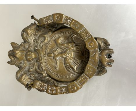 A reproduction heraldic inspired cast brass door knocker of shield shape with swan surmount above roundel with a knight on ho