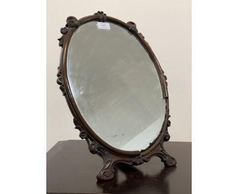 Property of the Late Countess Haig. An Edwardian walnut framed easel mirror, the frame carved with trailing foliate, and havi