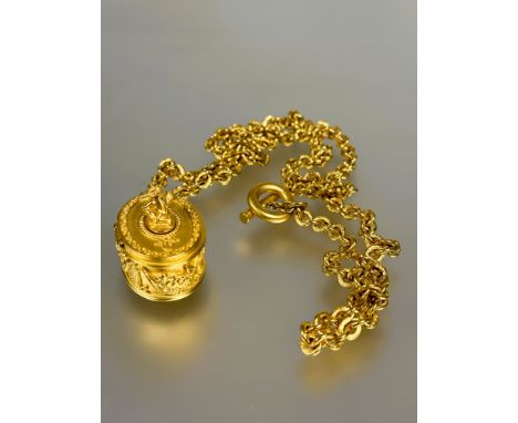 A vintage Karl Lagerfeld 1980s- 90s gilt oval pill box pendant on oval link chain, the hinge top mounted seated cherub enclos