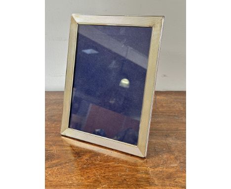 A 1920s large silver rectangular photograph frame with engine turned decoration and hardwood back and easel stand aperture H 