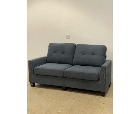 A modern two seat sofa upholstered in steel blue fabric and raised on tapered block supports. H90cm, W162cm, D85cm.&nbsp;