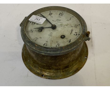 A mid 20th century brass twin train ships bulkhead clock, the white enamel dial with Arabic chapter ring inscribed 'Schatz Ro