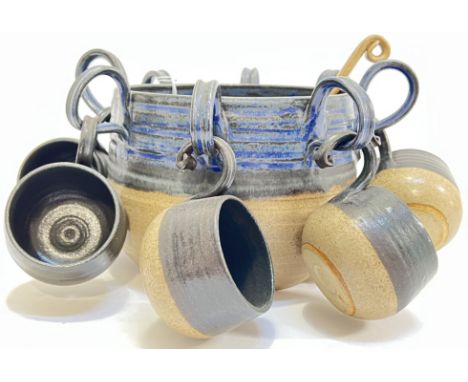 A Scottish studio pottery loop-handled punch bowl (impressed mark, h- 17cm, w- 28cm) with six cups (two missing) and a ladle&