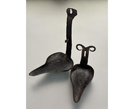 A late 18thc early 19thc cast iron crusie wall mounting pair of oil lamps with patinated finish tip of lower lamp with V shap