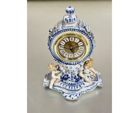 A 19thc continental drum head porcelain blue and white Meissen style mantle clock case with knop to top and circular dial wit