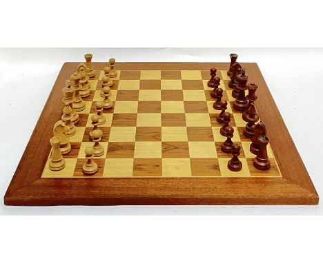 A large birch and walnut veneered chessboard (50cm X 50cm), together with pieces (missing one pawn)