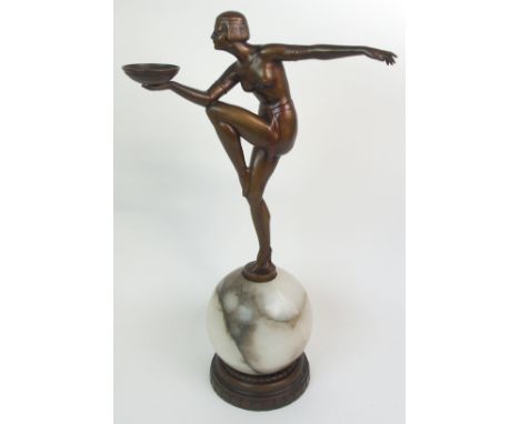 AN ART DECO LADY LAMP modelled as a bronzed naked female dancer standing on one leg upon an alabaster shade and holding aloft