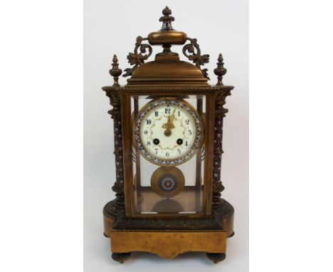 A FRENCH CHAMPLEVE ENAMEL, BRASS AND GLASS MANTLE CLOCK the enamelled dial with painted swag decoration and Arabic numerals, 