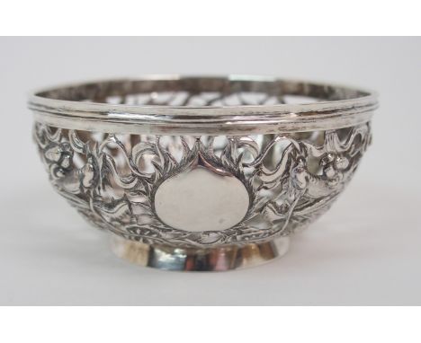 A CHINESE SILVER PIERCED BOWL decorated with dragons surrounding the flaming pearl,56 grams  7.7cm diameter Condition Report: