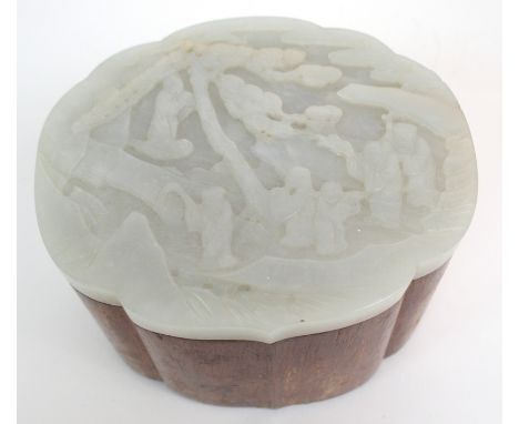 A CHINESE OCTOFOIL HARDWOOD AND JADE COVERED BOX carved with figures beneath a pine tree, 8.5cm high, 12cm wide and 10cm deep