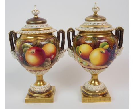 A PAIR OF ROYAL WORCESTER TWO-HANDLED JARS AND COVERS each painted with apples, peaches, grapes and blackberries, one signed 
