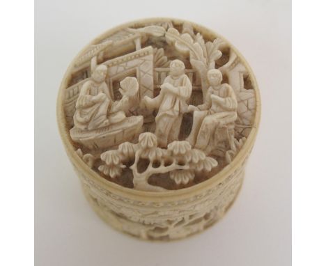 A CANTON CARVED IVORY GAME COUNTER BOX decorated with figures and containing mother of pearl counters, eight 3.5cm diameter, 