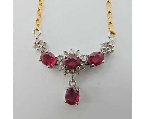 AN 18CT GOLD RUBY AND DIAMOND NECKLACE set with four rubies enhanced with diamonds, dimensions of gem set area 3cm x 1.5cm, l