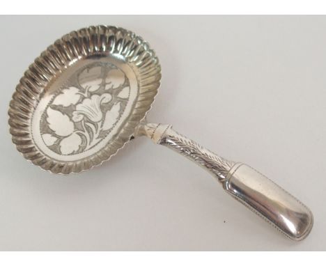 A SILVER CADDY SPOON by John Thropp, Birmingham 1817, the oval bowl with foliate engraving and ribbed rim, 7.5cm long Conditi