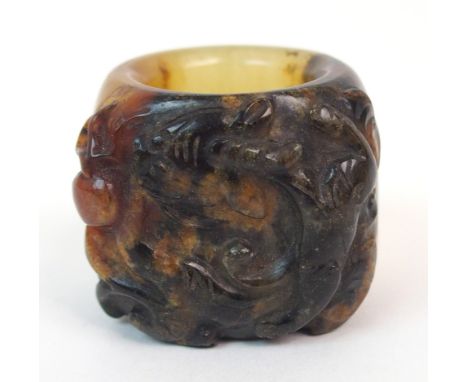 A CHINESE HARDSTONE ARCHERS RING carved with a dragon chasing a flaming pearl, 2.8cm high Condition Report: Available upon re
