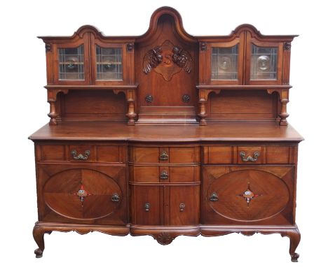 A WYLIE AND LOCHHEAD MAHOGANY SIDEBOARD the upper section with carved cherubs and inlay flanked by leaded glass doors over ba