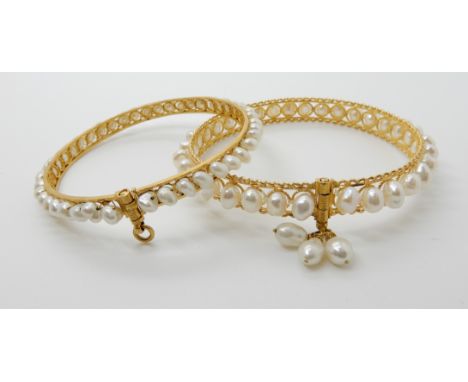 TWO BRIGHT YELLOW METAL AND PEARL BANGLES both with filigree and wire work detail, the pearls are sewn into place along the l