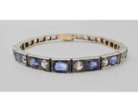 A SAPPHIRE AND CLEAR GEM SET VINTAGE BRACELET grain set to the yellow and white metal bracelet mount, with wigglework engravi