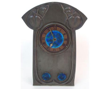 AN ARCHIBALD KNOX PEWTER MANTLE CLOCK the round copper dial with black Roman numerals on chapter ring and a blue and green en