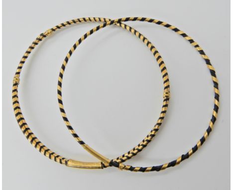 TWO ELEPHANT HAIR BANGLES with decorative yellow metal design holding the two hairs in place, inner diameter 6.8cm, width app