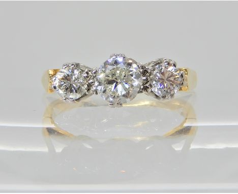 AN 18CT YELLOW AND WHITE GOLD THREE STONE DIAMOND RING of estimated approx 0.80cts combined. Finger size O, weight 3.4gms Con