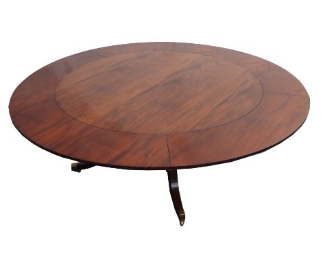 A GEORGIAN STYLE MAHOGANY JUPE STYLE CIRCULAR DINING TABLE with five curved leaves above a four pillar column base joined by 