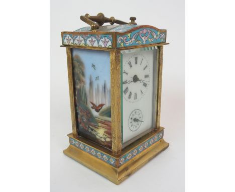 A 20TH CENTURY CHAMPLEVE ENAMEL AND BRASS REPEATER CARRIAGE CLOCK with painted enamel side panels, the dial with Roman numera