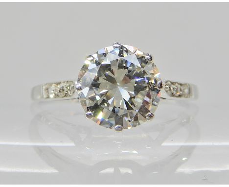 AN OLD CUT DIAMOND SOLITAIRE RING of estimated approx 2cts, old cut diamonds set to the shoulders, set throughout in white me