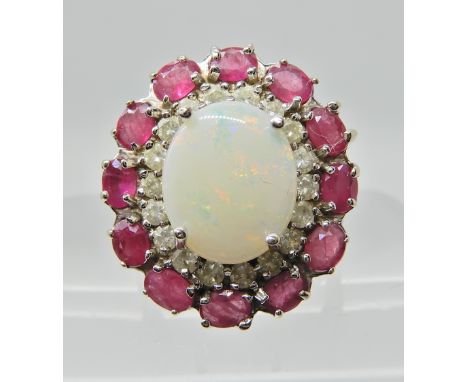 A 14K WHITE GOLD OPAL DIAMOND AND RUBY RING the white opal measures 12mm x 10mm, with a circlet of diamonds estimated approx 