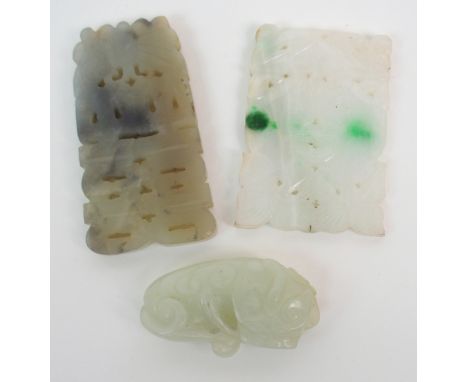A CHINESE JADE CARVING OF A CHILD with a floral spray, 5cm wide and two hardstone pierced carvings, 6cm and 7cm wide (3) Cond