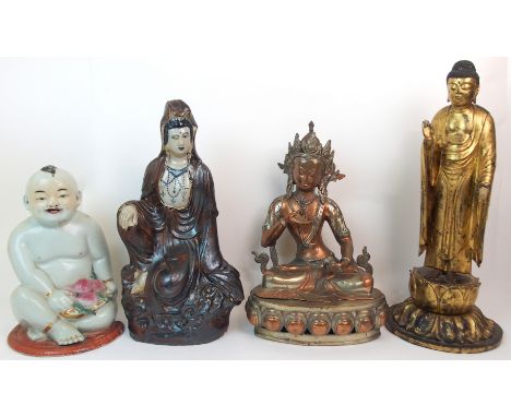 A CHINESE GILT-WOOD CARVED FIGURE OF A BUDDHA standing on a lotus throne (some damages), 51cm high, ceramic figure of Guanyin
