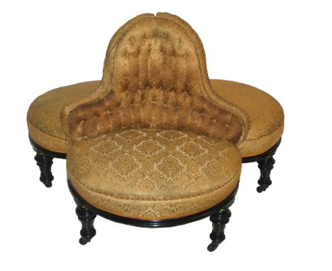A VICTORIAN EBONISED CONVERSATION SEAT set with three button back upholstered scroll seats on baluster fluted legs with ceram
