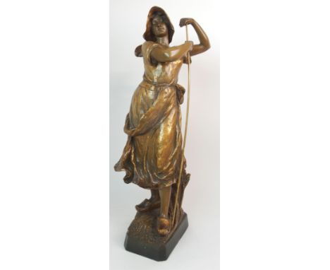 A GOLDSCHEIDER GILDED TERRACOTTA FIGURE OF A FARM GIRL modelled standing on a base of wheat, with impressed mark and numbers 