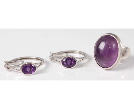 A contemporary white metal and cabochon amethyst set dress ring, stamped 925, size N, together with a white metal and amethys