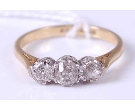 An 18ct gold diamond three stone ring, the centre round cut diamond weighing approx 0.25ct, 3.4g, size O