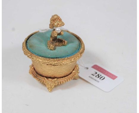A Mirella gilt metal trinket box, the pin cushion cover surmounted by a dog with faux pearl 