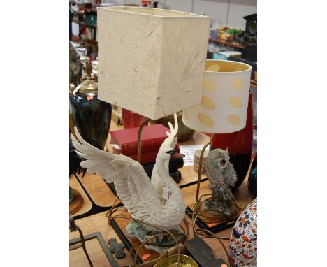 A modern table lamp surmounted by a resin owl on a faux walnut base with circular shade, height 55cm; together with one other