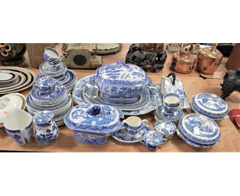 A large collection of blue and white transfer decorated dinner wares, mainly in the Willow pattern, by various factories to i