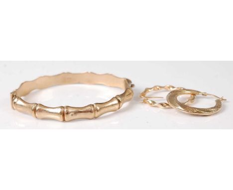 A 9ct gold simulated bamboo hinge bangle, 9.6g, dia. 67mm, together with two modern hollow 9ct gold ear hoops 2g (3)Condition